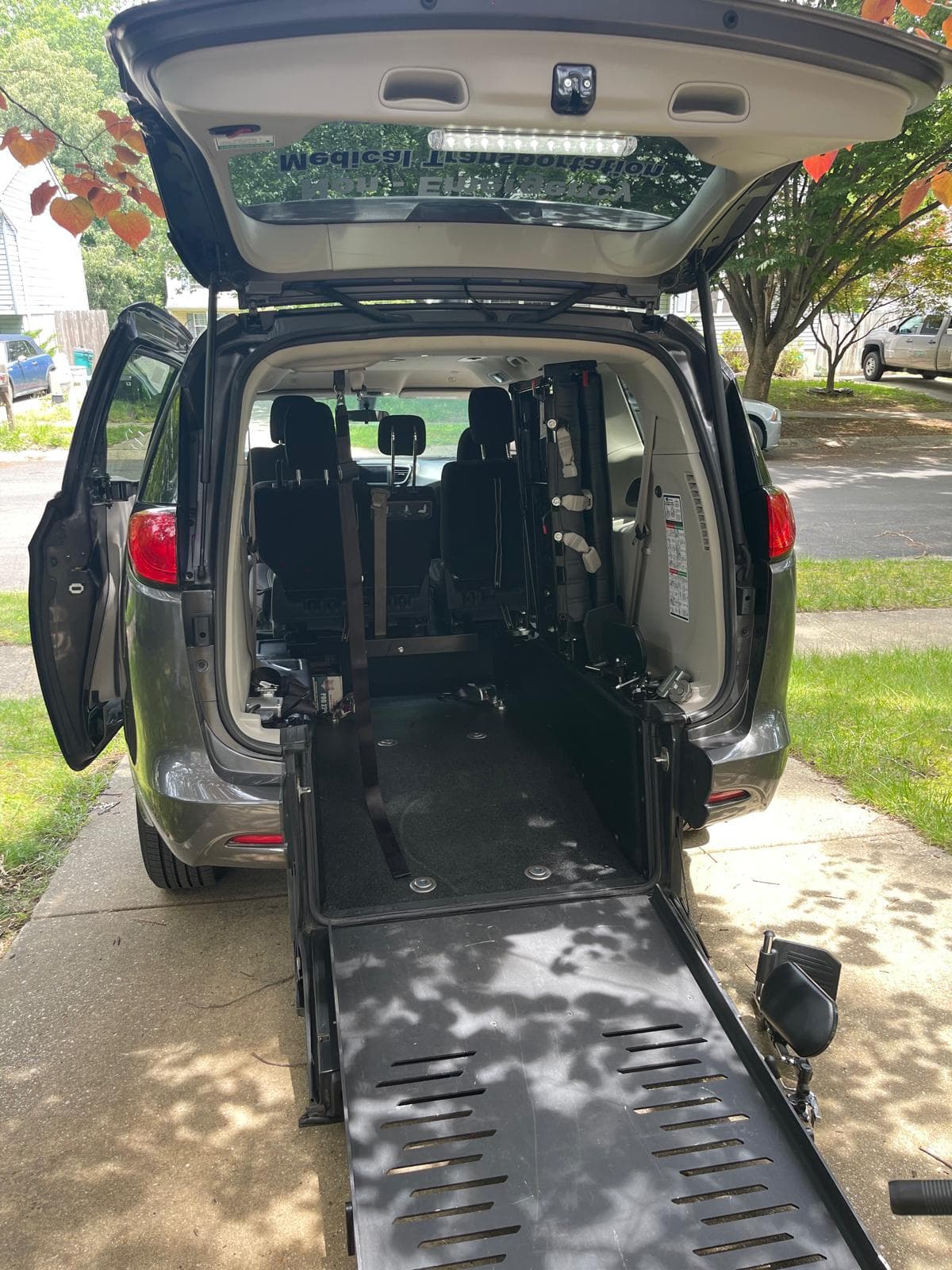 Stamerck Enterprise wheelchair accessible vehicle interior showing hydraulic ramp and wheelchair securement area